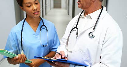 Doctors interacting with each other in corridor