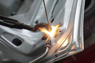 Closeup for welding auto body with gas torch