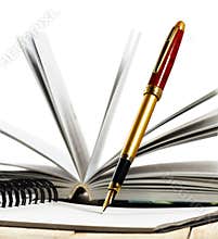 Image of book and pens closeup