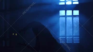 Girl silhouette dancing contemporary in backlight of moonlight from window