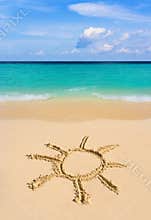 Drawing sun on beach