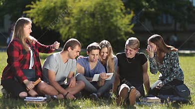 Handsome students working with touchpad in park