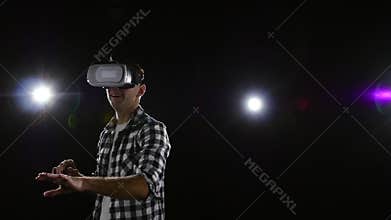 Guy with delight watching in virtual reality glasses. Slow motion