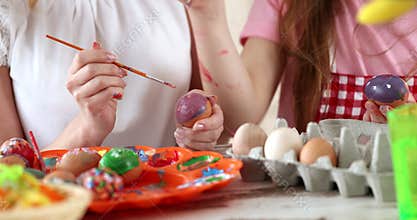 Easter painting â€“ mother with daughter coloring eggs