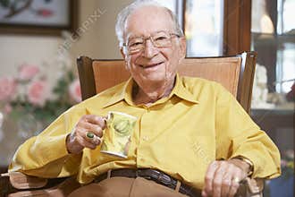 Senior man drinking hot beverage