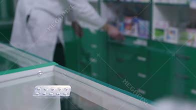 Close-up of pills in blister pack lying on counter