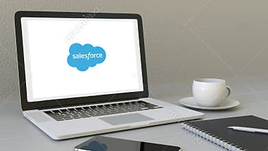 Opening laptop with Salesforce logo on the screen. Modern workplace conceptual editorial 4K clip