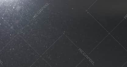 Dust particles fast moving over black background from left corner