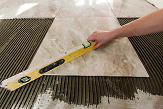 Ceramic tiles and tools for tiler. Floor tiles installation. Home improvement, renovation - ceramic tile floor