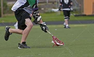 Boys Lacrosse scooping up the ball