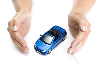 Woman hands holding blue car isolated on white