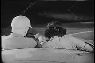 Rear view of two people driving in sports car