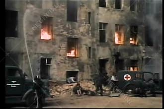 Historical reenactment of men extinguishing fire during World War II
