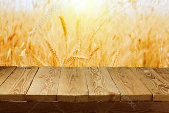 Wheat field background and empty wooden deck table