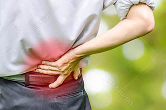 Close up of a man holding his back in pain