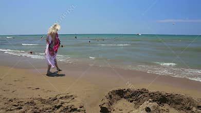 Woman in dress trying warm water.