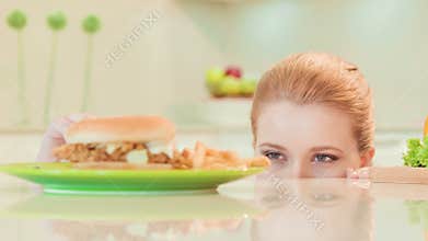Young woman choosing between healthy food and not