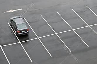 Single car in empty parking lot