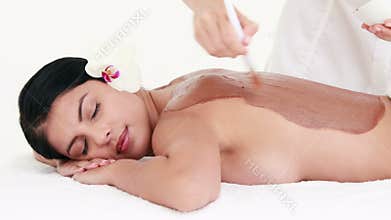Woman getting a beauty treatment on back