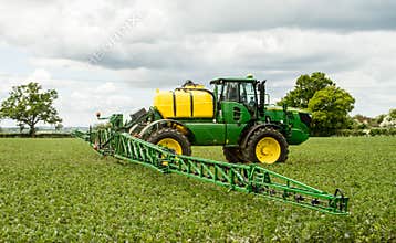 John Deere sprayer spraying in bean field