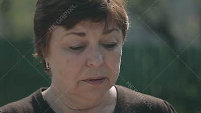 Close up of the sad mother accompanies her son to