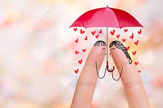 Conceptual finger art of a Happy couple. Lovers are kissing under umbrella. Stock Image