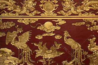 Sculptured phoenix and dragons decorate an altar in a buddhist temple in Hoi An (Vietnam)
