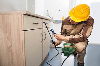 Pest control worker spraying pesticides