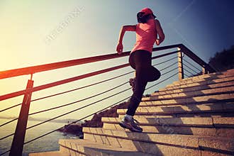 Healthy lifestyle sports woman running up on stone stairs