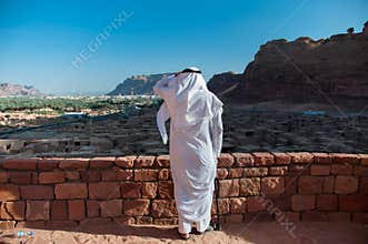 Saudian overlooking the old city of Al Ula, Saudi Arabia