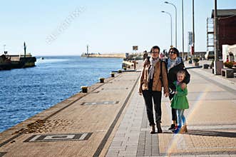 Family walking by Baltic Sea