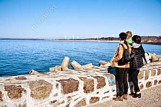 Family on seawall at Baltic Sea