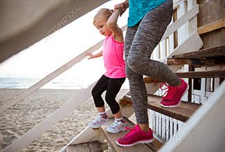 Mother and baby girl walking down the stairs