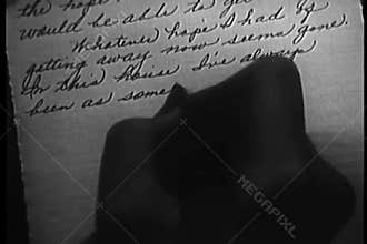 Close-up of woman writing a letter in script