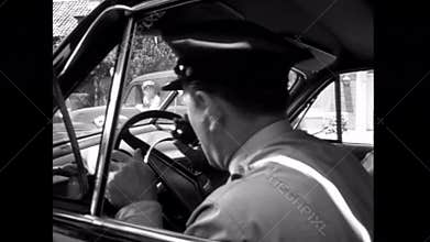 Officer in police car calling for backup