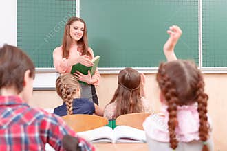 Pupils raising their hands during classes