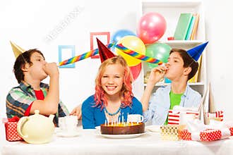 Birthday party with boys blow noisemaker horns