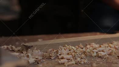 Man hands with carpenters plane production of oak