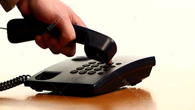 Businessman making a phone call on landline