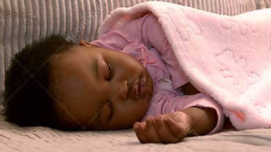 Baby girl sleeping on the sofa