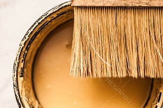 Brush and yellow paint closeup