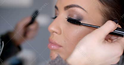 Beautician applying mascara