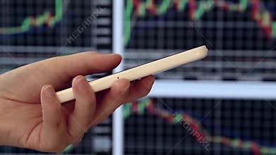 Pan shot of woman checking smart phone stock information