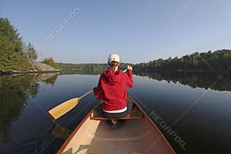 Woman Paddling a Canoe on a Northern Ontario Lake