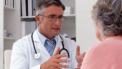 Doctor speaking with his patient at desk