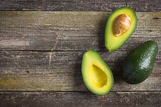 Food background with fresh organic avocado on old wooden table