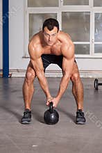 Crossfit - kettlebell training man in a gym