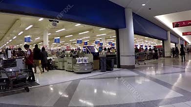 Customer buying foods at superstore checkout counter