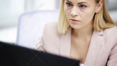 Stressed businesswoman with computer at office