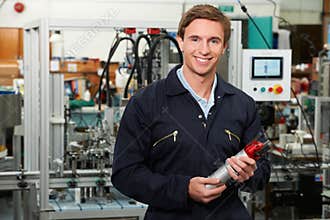 Portrait Of Engineer Holding Component In Factory